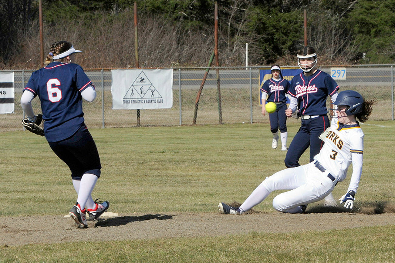 Lonnie Archibald/for Peninsula Daily News
Forks' Keira Johnson slides in safely with a steal of second base during the Spartans' doubleheader with Pe Ell on Wednesday at Tillicum Park in Forks.