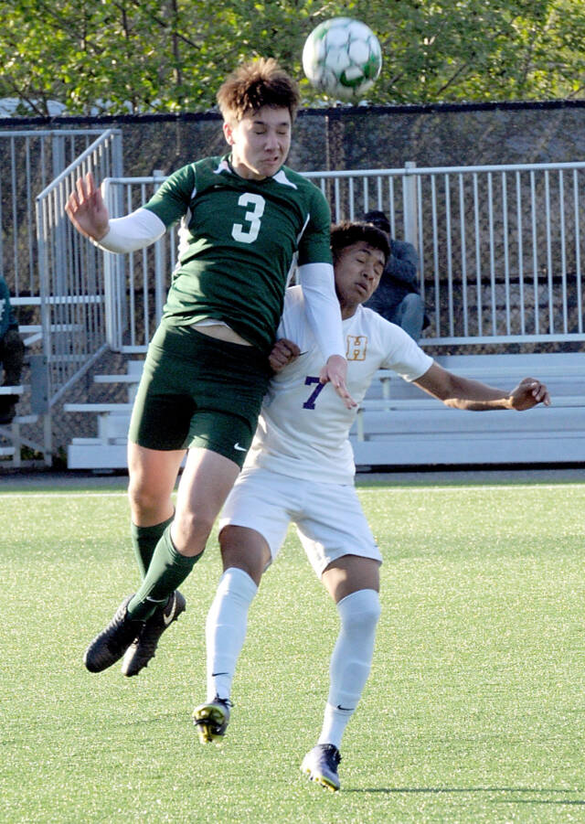 Port Angeles’ Landon Close, left, goes up and over Highline’s Yonatan Garcia-Arevalo on Tuesday in Port Angeles. (Keith Thorpe/Peninsula Daily News)