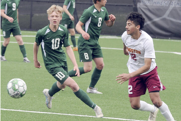 Port Angeles’ Matthew Miller, left, chases a loose ball ahead of Kingston’s Edwin Vallecillo, right in a match this season in Port Angeles. (Keith Thorpe/Peninsula Daily News)