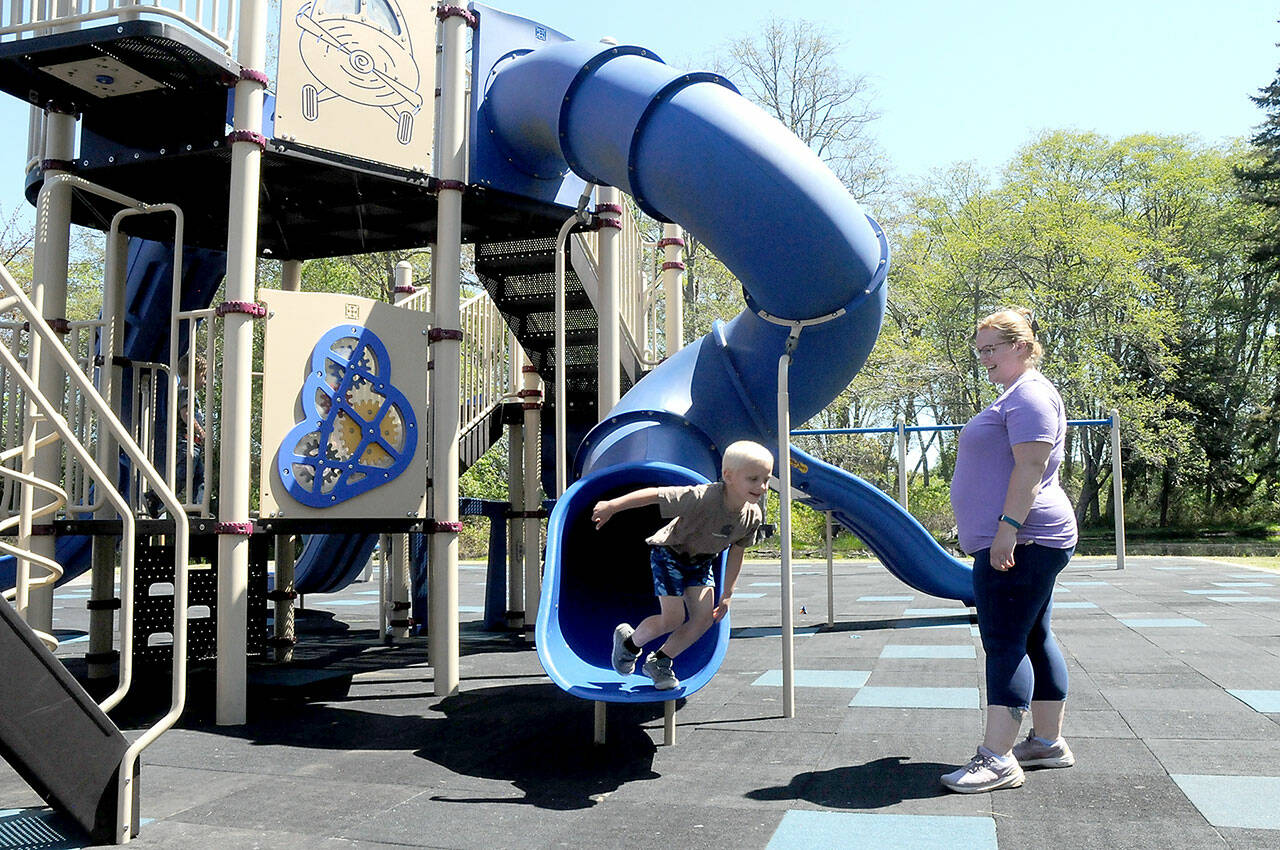 Four-year-old Collin Windrich bolts from a slide on the playground at Shane Park in Port Angeles as his mother, Lissa Windrich of Sequim, watches on Tuesday. (KEITH THORPE/PENINSULA DAILY NEWS)