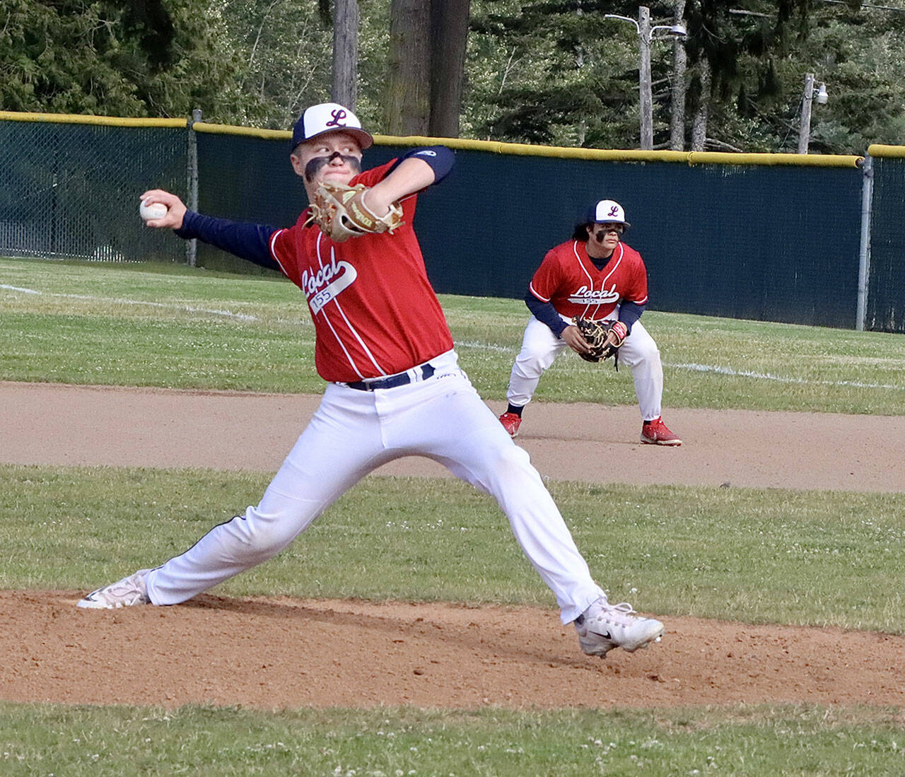 Brandt Perry pitches for Local 155 in the Olympic Junior Babe Ruth championship game against Athletes Choice on Thursday night at Volunteer Field. Playing first base is Chris Jaynes. It was a pitchers’ duel as the game went into extra innings. Local 155 ended up winning 3-2 on a walk-off, finishing the season 13-1. (Dave Logan/for Peninsula Daily News)