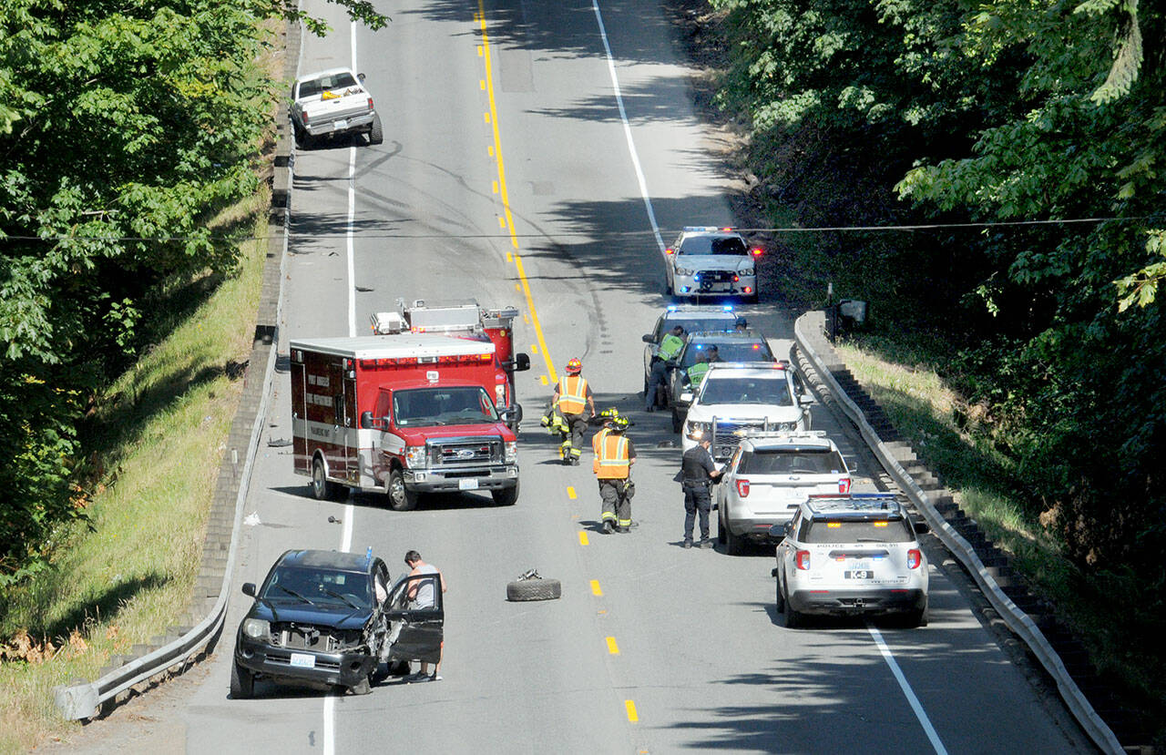 Emergency vehicles respond to the scene of a collision that closed a portion of U.S. Highway 101 near the Tumwater Truck Route east of Fairmount Avenue on Tuesday afternoon. (Keith Thorpe/Peninsula Daily News)