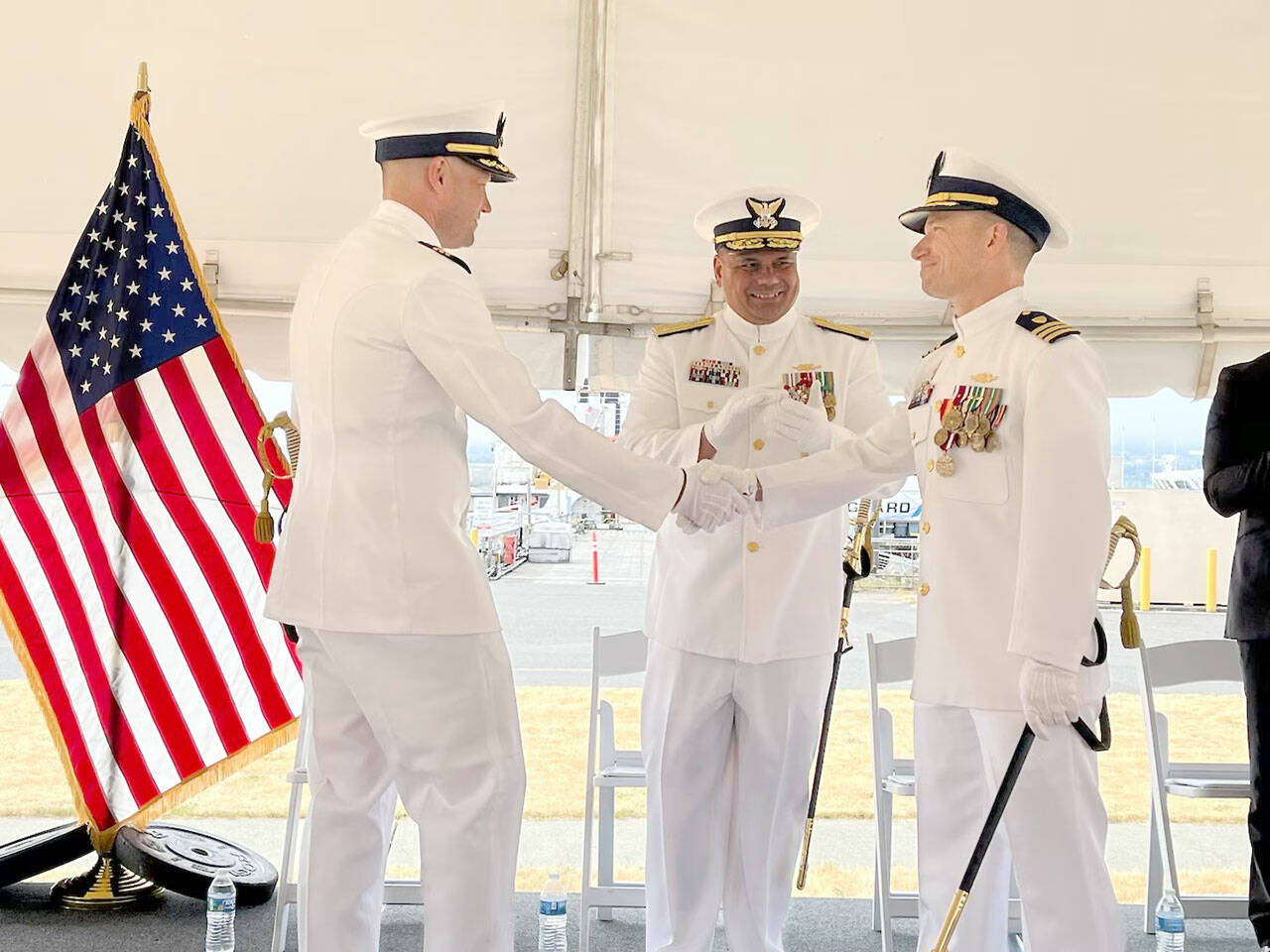 Cmdr. Adam Disque, left, is the Coast Guard cutter Active's 30th commanding officer. He relieved Cmdr. Brian Tesson, right. Vice Adm. Andrew Tiongson, commander Coast Guard Pacific Area, center, presided over last week's ceremony.