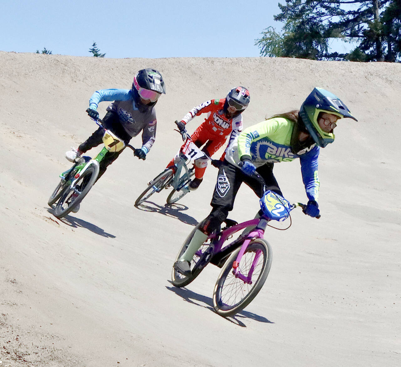 Lincoln Park BMX hosted a state-qualifying event Sunday, attracting 366 racers of all ages from all across Washington, trying to qualify for the state BMX championship scheduled at Lincoln Park BMX on Sept. 24. From left is Nyah Langdon of Port Angeles, Ava Burke of Gig Harbor and Makaylie Underwood of Port Angeles in the expert 12 girls moto. (Dave Logan/for Peninsula Daily News)