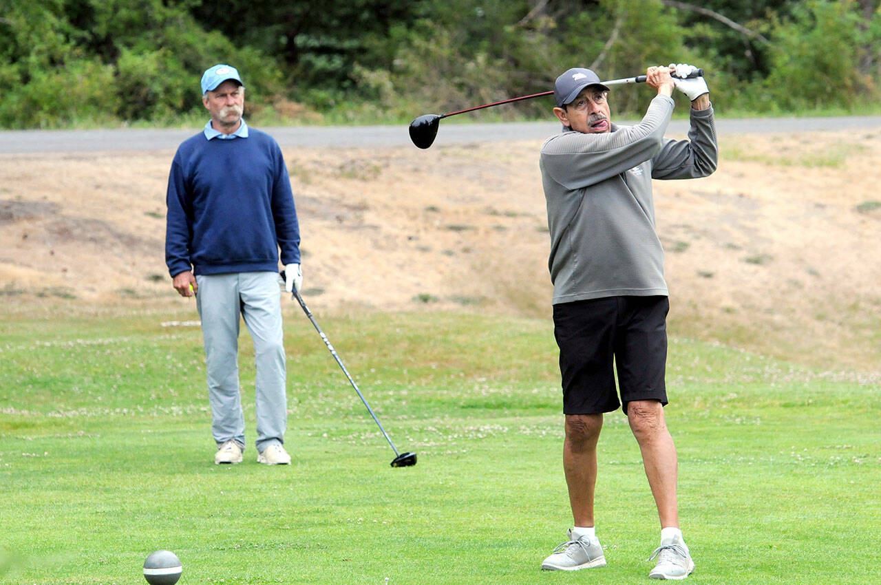 Gary Valencia of Port Angeles, right, tees off at the start of the Clallam County Amateur tournament on Friday at Peninsula Golf Course as Scott Hendricks, also of Port Angeles, awaits his turn.
KEITH THORPE/PENINSULA DAILY NEWS