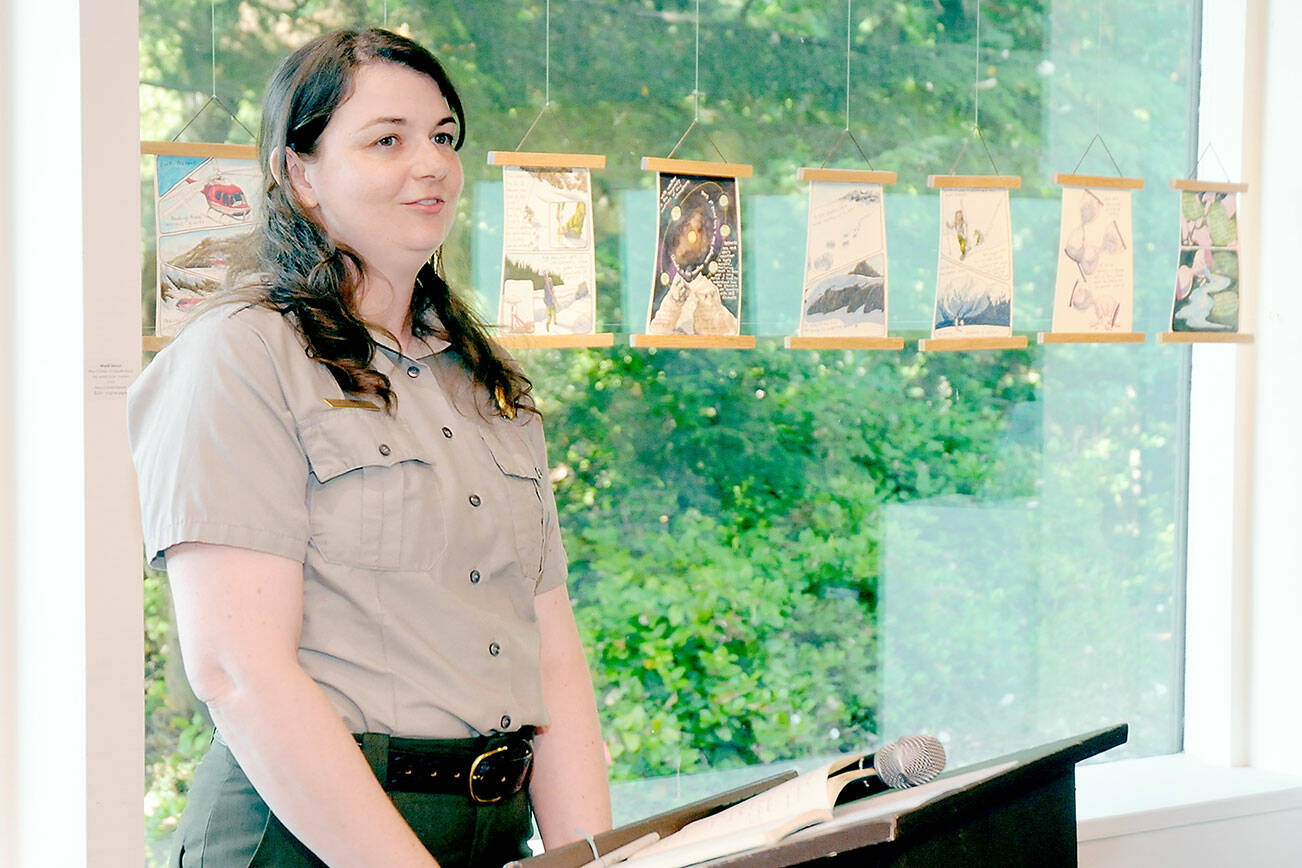 KEITH THORPE/PENINSULA DAILY NEWS
Olympic National Park Arist-in-Residence Program manager Eliza Goode provides an introduction to "Terminus: A Glacier Memorial Project" during an opening reception for a collection more than 40 art pieces themed around the effects of climate change on glaciers on Friday at the Port Angeles Fine Arts Center. Most most of the installations will be exhibited at the fine arts center through Sept. 3. The center is open from 11 a.m. to 5 p.m. Thursdays through Sundays.