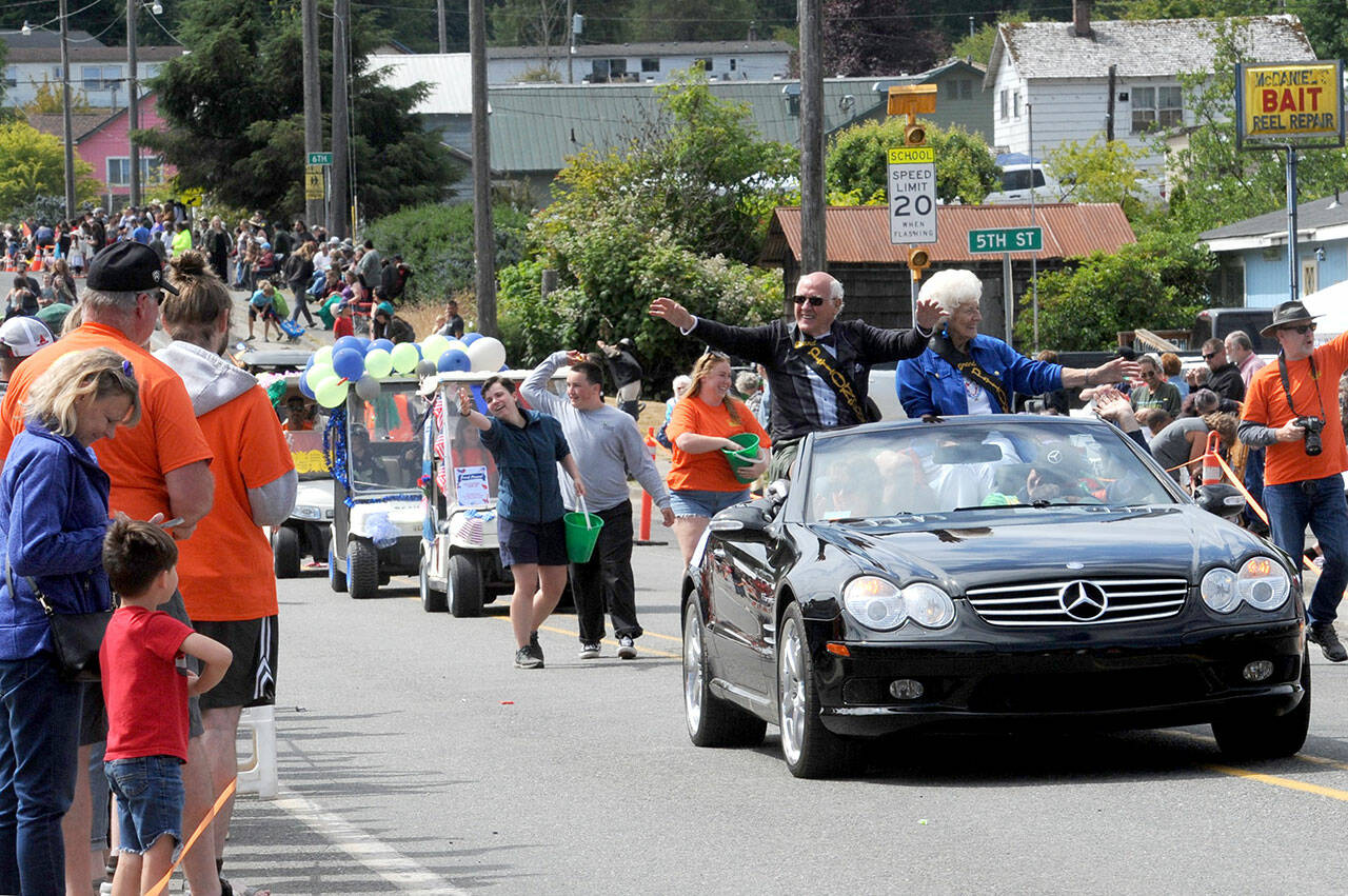 Wes Fitzpatrick and Lorna Konopaski, grand pioneers for the Clallam Bay-Sekiu Fun Days parade, wave to the crowd on Saturday. The three-day celebration ended Sunday with a beach cleanup, fun run, tournaments and other activities. (Lonnie Archibald/for Peninsula Daily News)