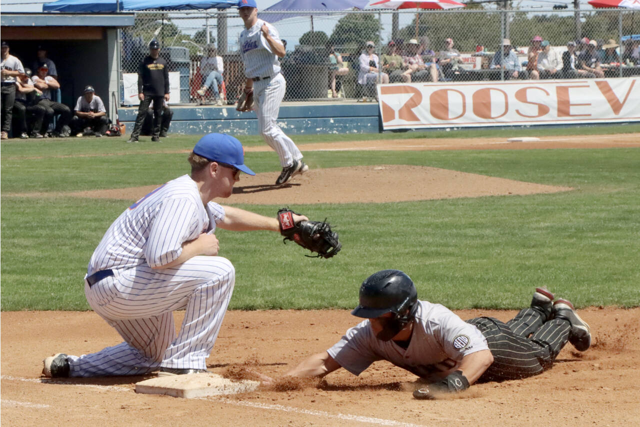 Port Angeles Lefties first baseman Owen Alsup takes the pickoff throw from his pitcher Reid Rasmussen to try to get Bend Elks runner Hunter Komine on Sunday at Civic Field in Port Angeles. Alsup later hit a home run. (Dave Logan/for Peninsula Daily News)
