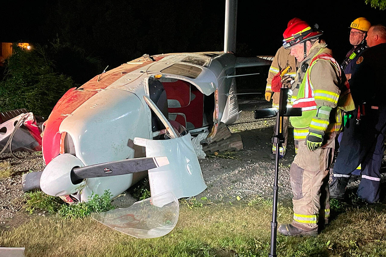 Firefighters with Clallam County Fire District 3 investigate a plane crash in Agnew on Saturday. (Matthew Nash/Olympic Peninsula News Group)