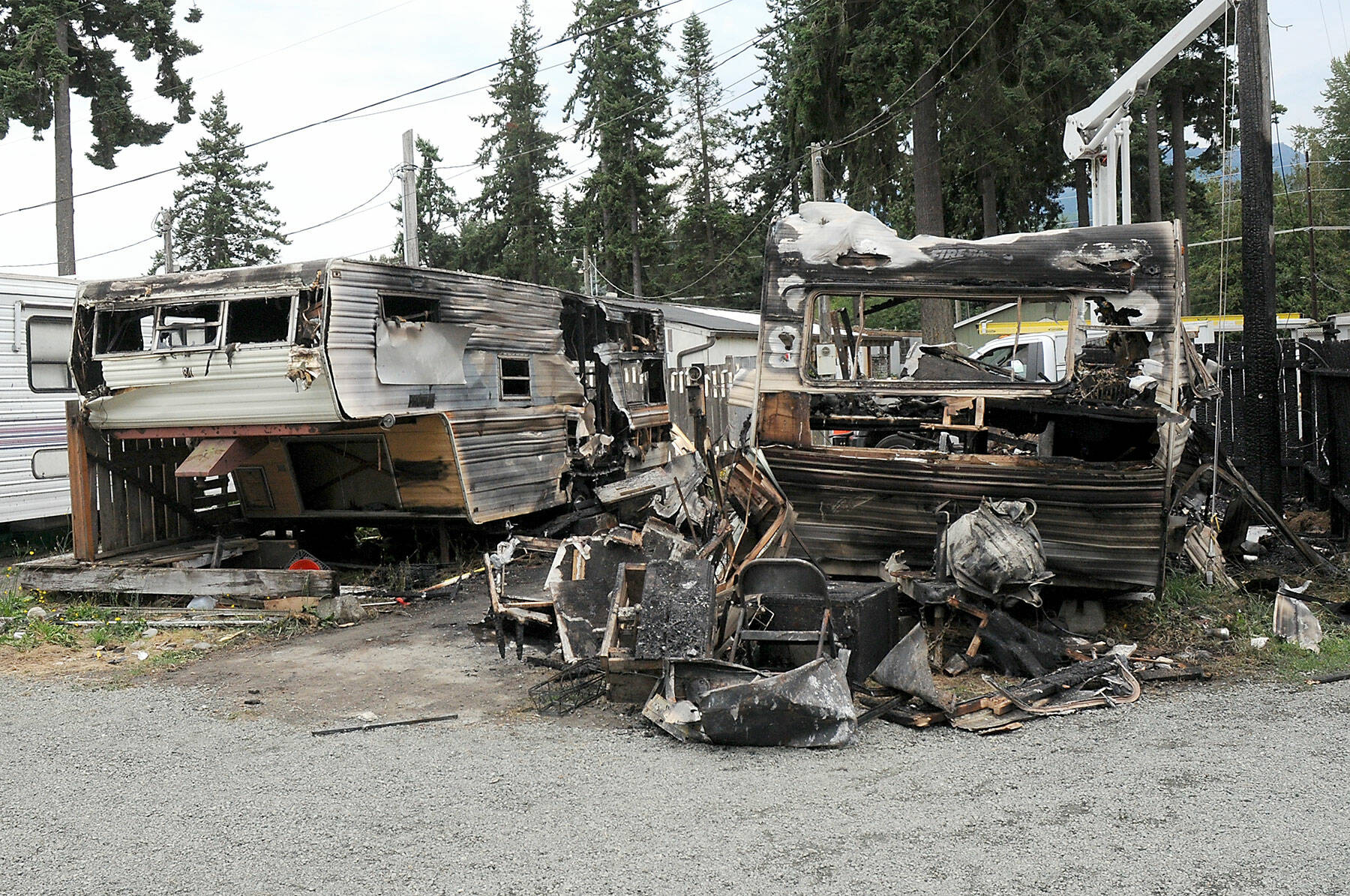 The charred remains of a pair of mobile homes sit on Saturday at the Emerald Mobile Home & RV Park in Port Angeles. (Keith Thorpe/Peninsula Daily News)