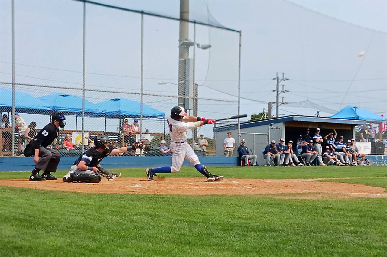 Port Angeles’ Julio Vasquez hits a fly ball in the second inning Sunday against the Bellingham Bells at Civic Field in Port Angeles. (Pierre LaBossiere/Peninsula Daily News)
