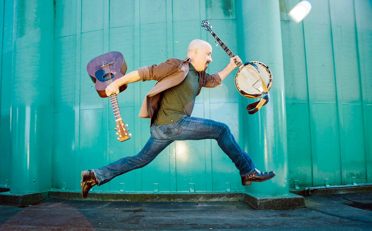 Tony Furtado clowns around with instruments.