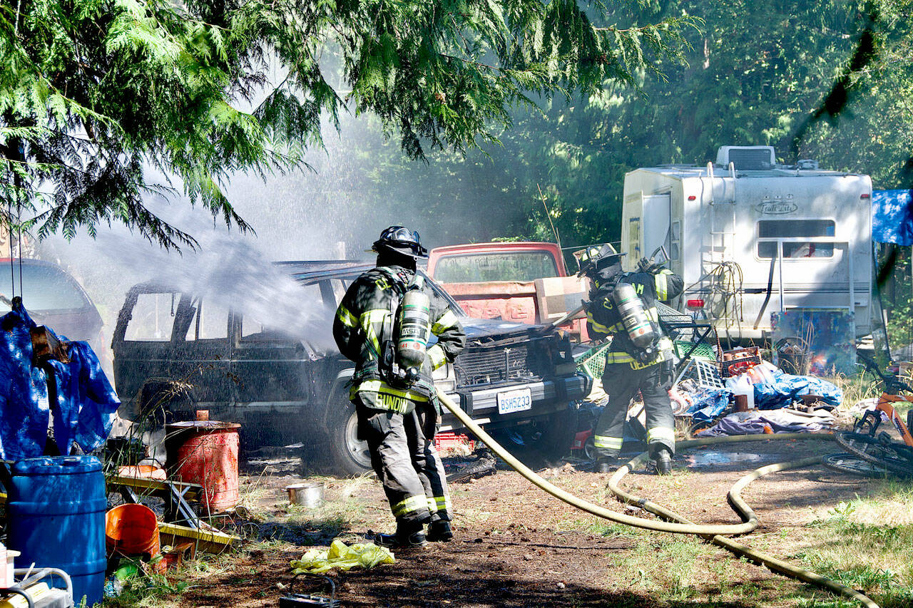 Clallam 2 Fire-Rescue firefighters battle a car fire on Lower Elwha Road.