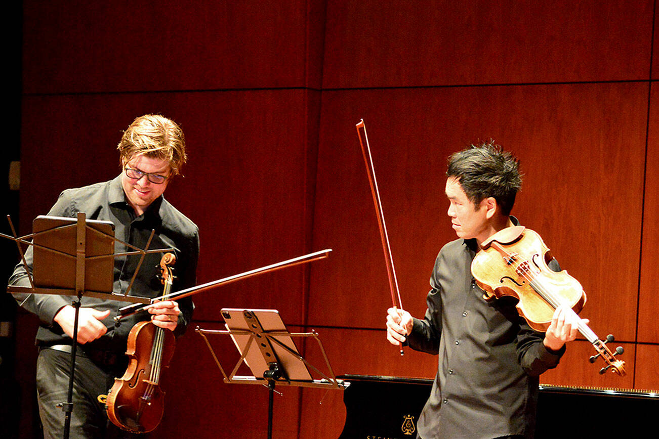 Music on the Strait cofounders James Garlick, left, and Richard O'Neill, pictured rehearsing, are bringing the festival to Field Arts & Events Hall and Maier Hall this week. photo by Diane Urbani de la Paz/For Peninsula Daily News