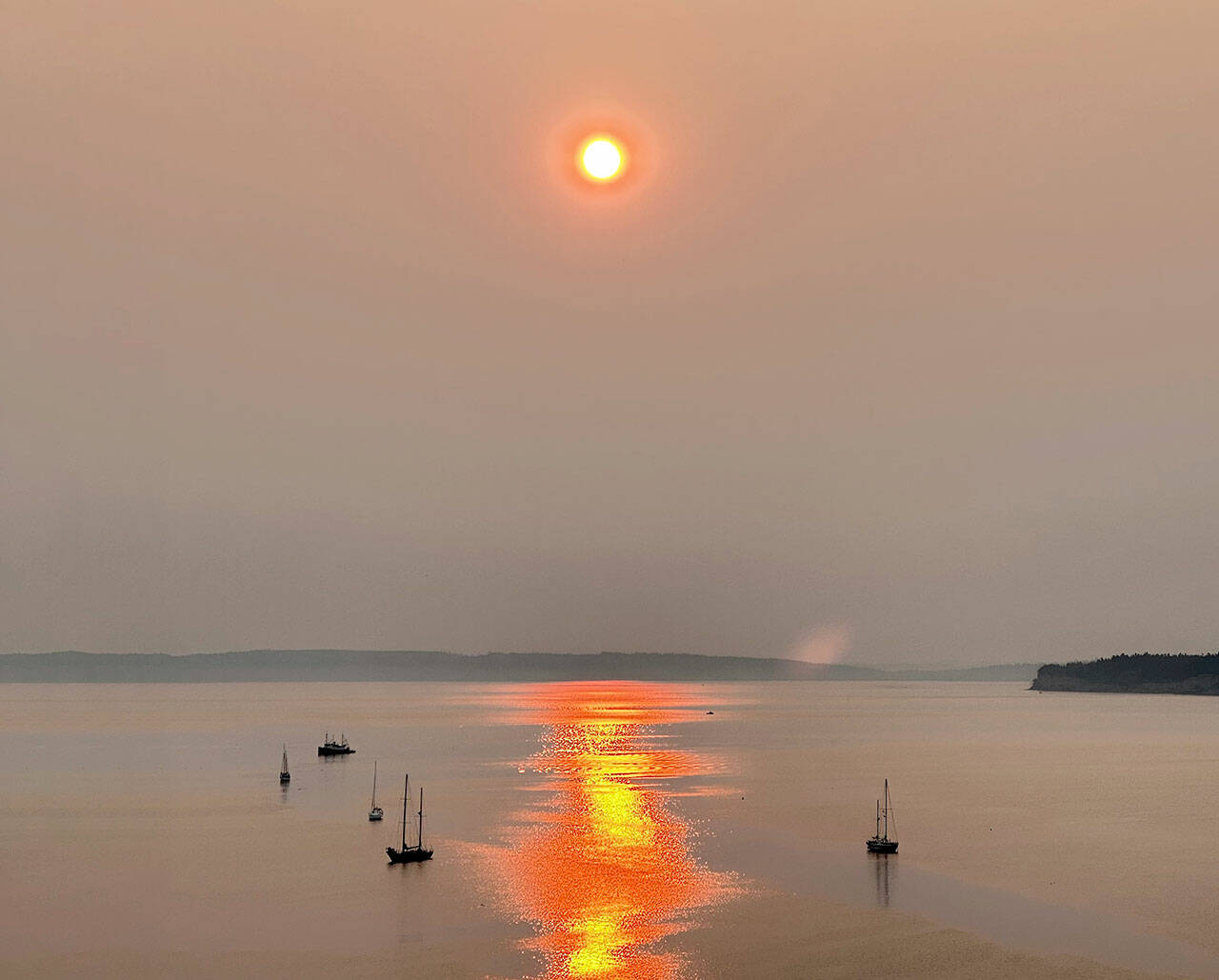 Smoke from wildfires in eastern Washington and Canada contribute to the red, smokey sunrise on Sunday over Port Townsend. (Steve Mullensky/for Peninsula Daily News)
