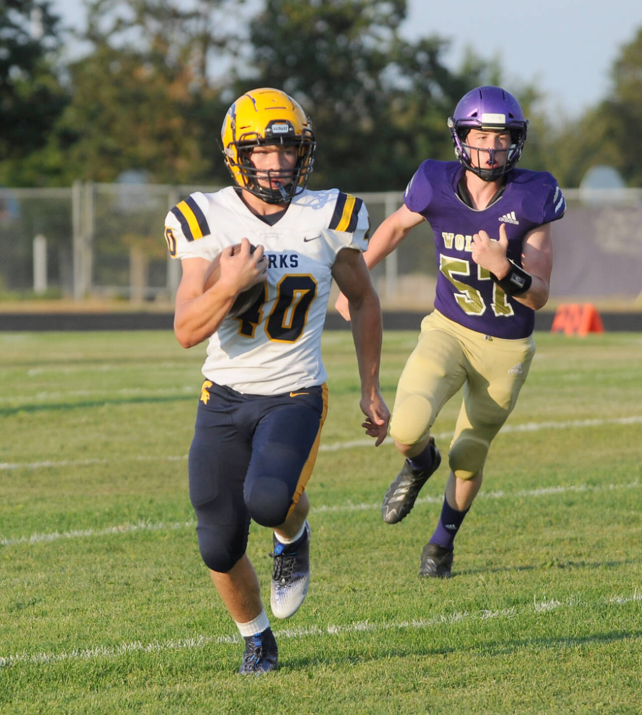 Forks’ Nate Dahlgren (40) busts loose for yardage during a 2022 game against Sequim. (Michael Dashiell/Olympic Peninsula News Group)