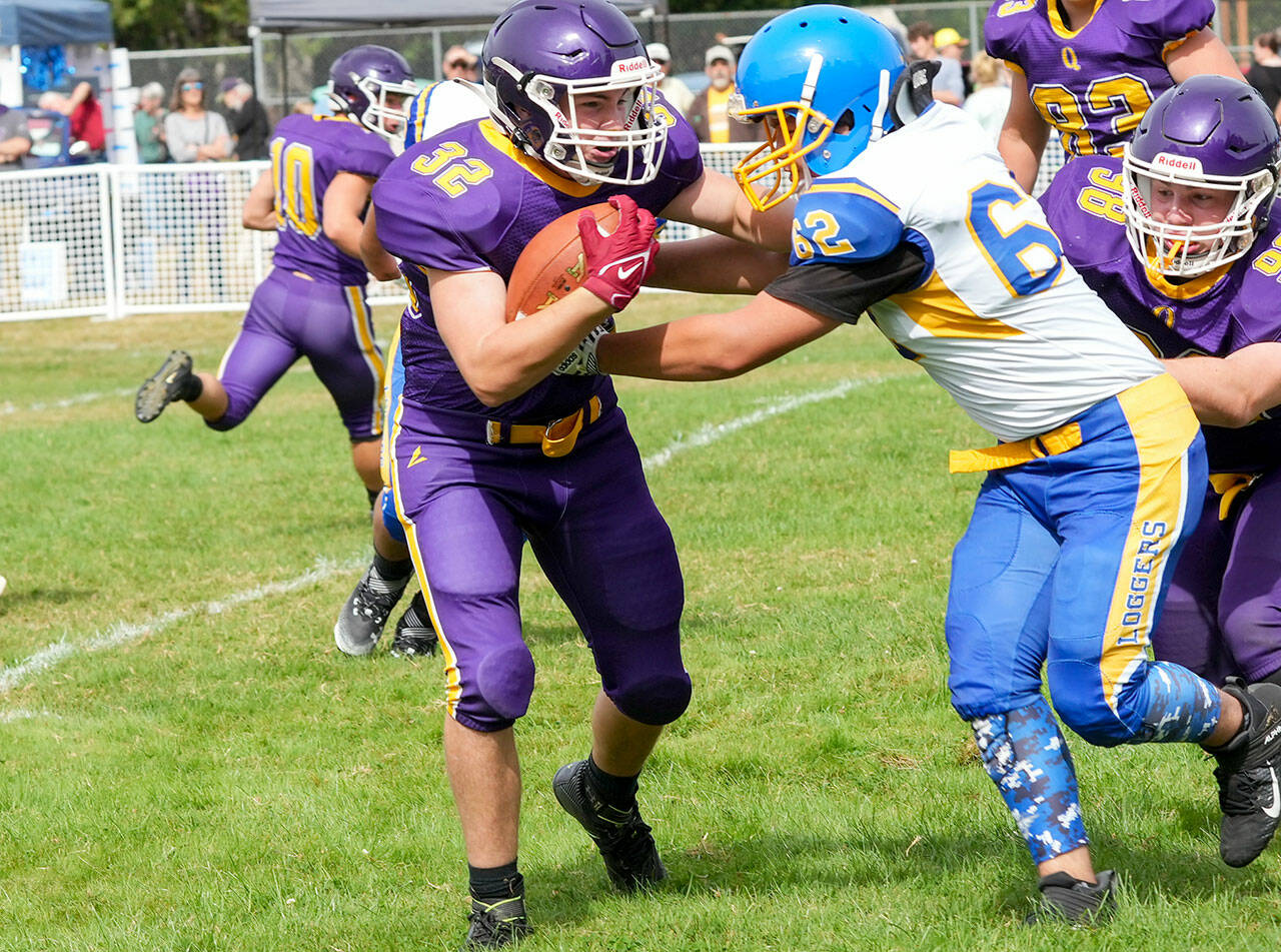 Steve Mullensky/for Peninsula Daily News Quilcene’s Mason Iverson, left, fights for yardage during a Sept. 2022 game against Crescent. Iverson led the Rangers in rushing yards last season and returns at fullback for Quilcene.
