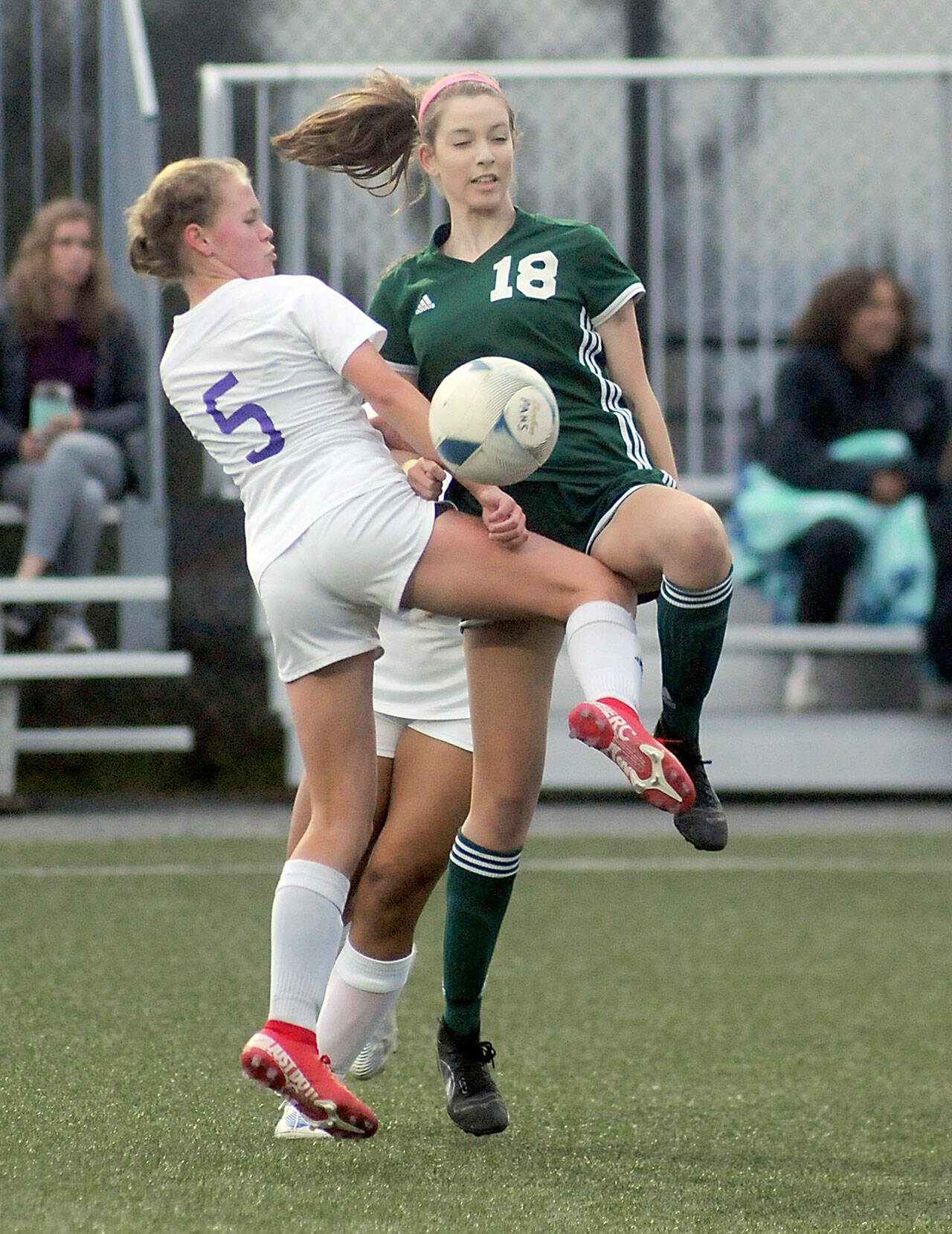 KEITH THORPE/PENINSULA DAILY NEWS Sequim’s Ivy Barrett, left, tangles with Port Angeles’ Kedryn DeScala during Thursday’s match in Port Angeles.