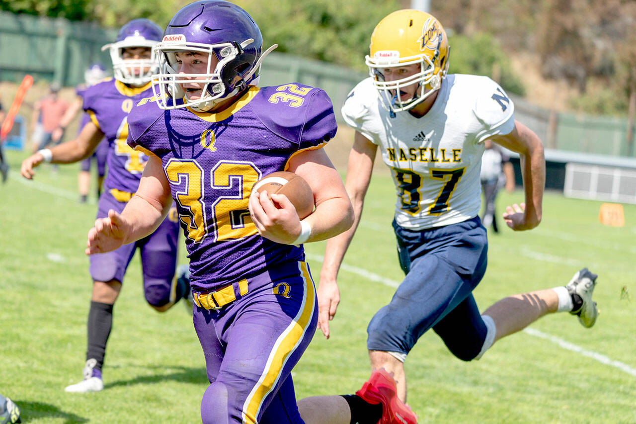 Quilcene’s Mason Iverson, 32, rushes around Naselle’s Jacob Pakanen and picks up a first down during a Saturday game played at Port Townsend’s Memorial Field. (Steve Mullensky/for Peninsula Daily News)