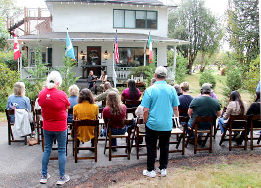 Author M.B. Thurman reads from her debut novel, “Summoned,” in front of the Miller Tree Inn, aka the Cullen House, during a pre-Forever Twilight in Forks event on Tuesday. M.B. (Mary Beth) and her husband Trent own the Inn. This week’s FTF Festival will also feature other authors at several other venues. (Christi Baron/Olympic Peninsula News Group)