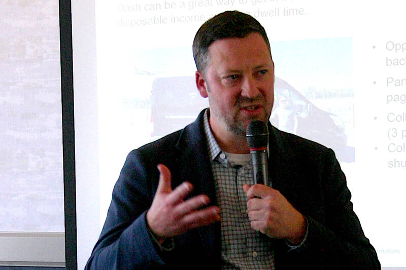 Dash Air Shuttle President Clint Ostler speaks to the Port Angeles Regional Chamber of Commerce on Wednesday about the regional carrier’s flight schedule and fares from Port Angeles to Seattle. Although Ostler did not give a date service would start, he said an announcement would be made “very soon.” (Paula Hunt/Peninsula Daily News)