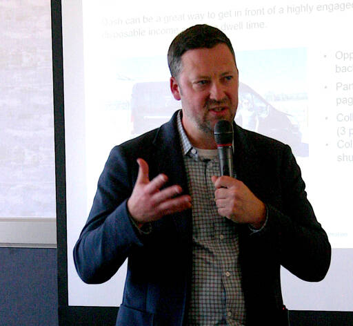 Dash Air Shuttle President Clint Ostler speaks to the Port Angeles Regional Chamber of Commerce on Wednesday about the regional carrier’s flight schedule and fares from Port Angeles to Seattle. Although Ostler did not give a date service would start, he said an announcement would be made “very soon.” (Paula Hunt/Peninsula Daily News)