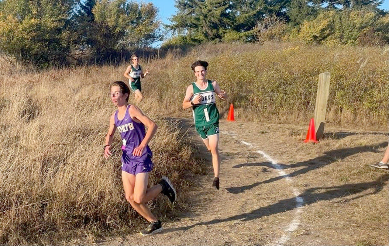 Angie Gooding/Port Angeles Cross Country
Port Angeles' Andre Campbell and Lucas Teague round a corner on the way to the finish line during an Olympic League Cross Country meet at Dungeness Recreation Area on Wednesday.