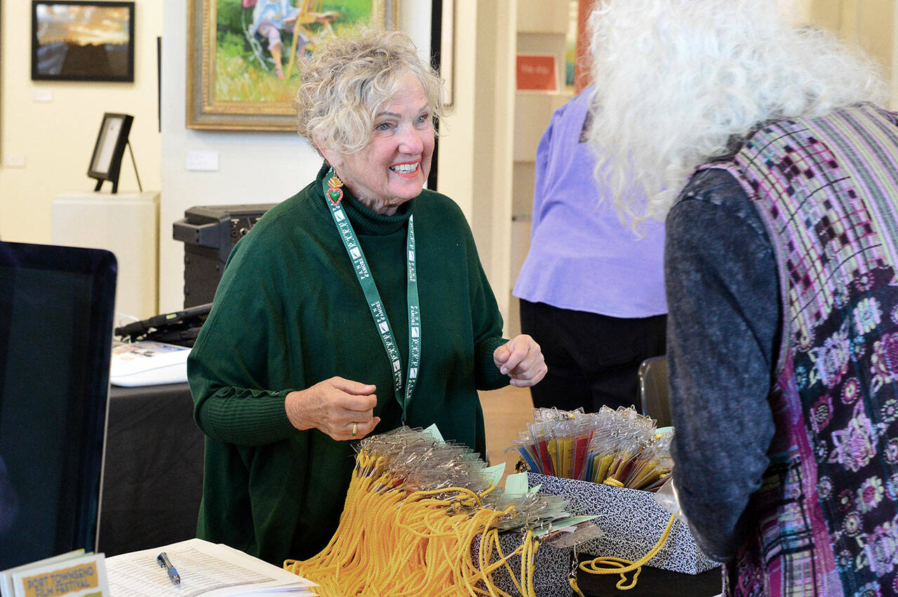 Port Townsend Film Festival volunteer Terry Wagner greets one of more than 700 festival passholders on Thursday. (Diane Urbani de la Paz/For Peninsula Daily News)