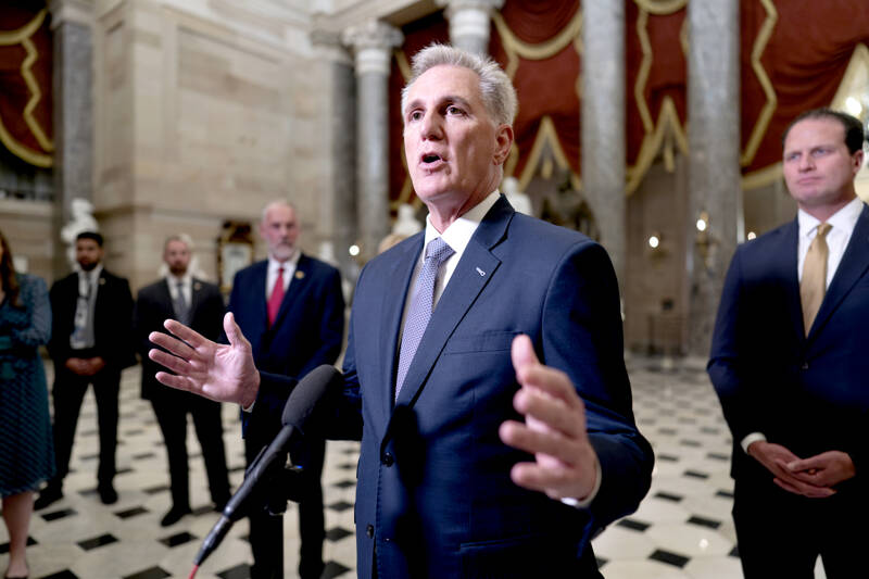 House Speaker Kevin McCarthy, R-Calif., joined by Rep. August Pfluger, R-Texas, right, and other GOP members, talks to reporters just after voting to advance appropriations bills on the House floor at the Capitol in Washington on Tuesday night. McCarthy is digging in on his refusal to take up Senate legislation designed to keep the federal government fully running beyond midnight Saturday. (J. Scott Applewhite/The Associated Press, File)