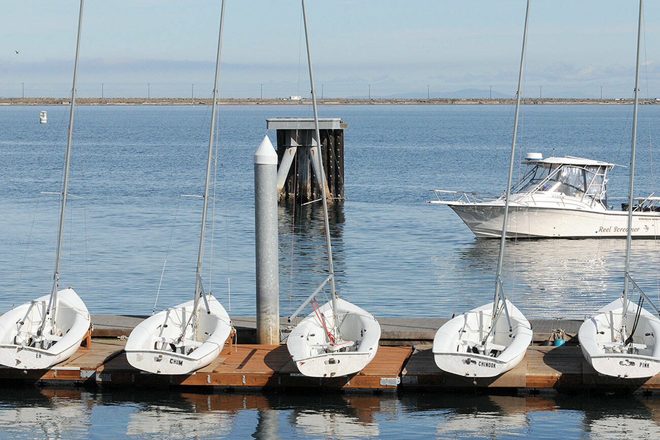 A fishing boat makes its way to the ramp at Port Angeles Boat Haven on Tuesday past a line of small sailboats belonging to the Community Boating Program for learn-to-sail classes. As the sailing season nears its end, the Port of Port Angeles plans to remove the floating docks at Boat Haven for the winter season on Oct. 16. (Keith Thorpe/Peninsula Daily News)