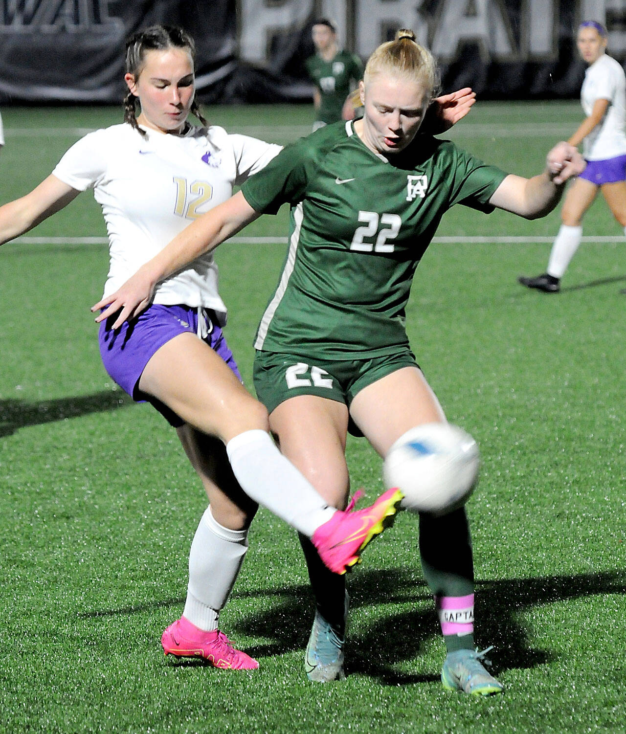 Sequim’s Olive Bridge, left, gets the ball away from Port Angele’ Paige Mason during Tuesday night’s match at Peninsula College in Port Angeles. (Keith Thorpe/Peninsula Daily News)
