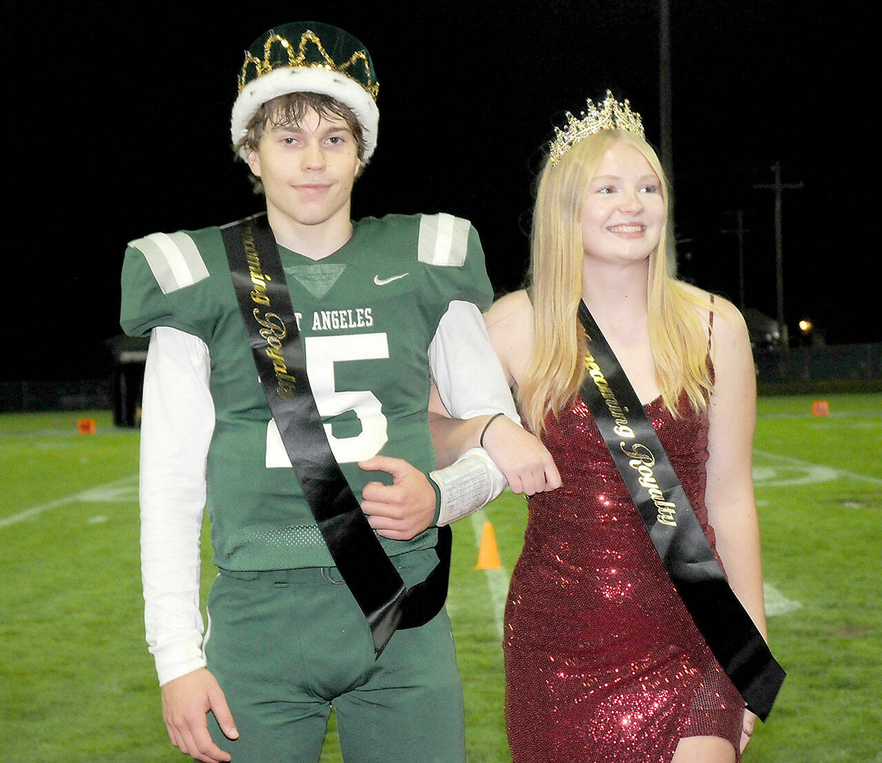 Port Angeles High School senior homecoming royalty King Parker Nickerson and Queen Paige Mason stand before an admiring crowd on Friday at halftime of the school’s football game against Bainbridge at Port Angeles Civic Field. (Keith Thorpe/Peninsula Daily News)