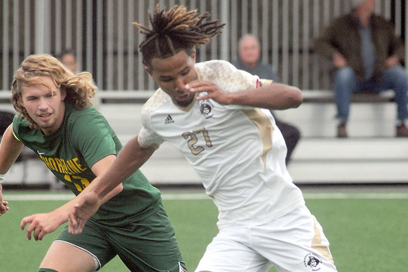 KEITH THORPE/PENINSULA DAILY NEWS
Peninsula's Abdurahim Leigh, right, dribbles past Shoreline's Brennon Odonnell during Saturday's match in Port Angeles.