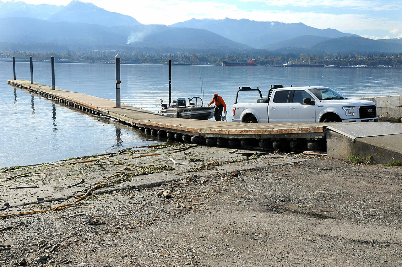 Kyle Kautzman of Sequim loads a boat onto a trailer at the boat launch on Ediz Hook on Thursday. The City of Port Angeles removed a second floating dock at the launch to protect it from adverse weather because repair parts are no longer available. (Keith Thorpe/Peninsula Daily News)