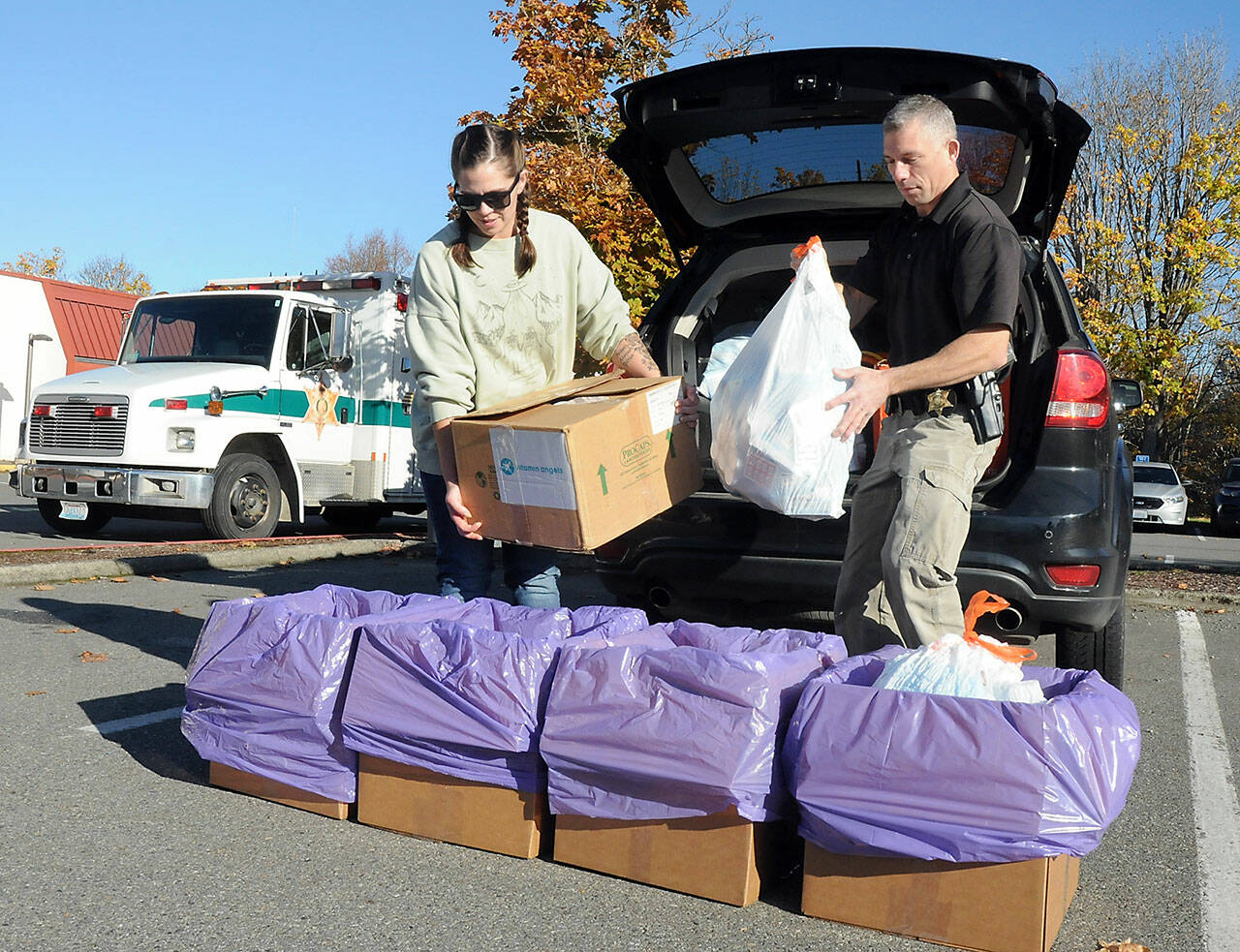 Helen Kenoyer of the Olympic Peninsula Community Clinic and Inspector Josh Ley of the Clallam County Sheriffs Office unload unwanted pharmaceuticals and medications from the agency at a drop-off point at the Clallam County Courthouse during Saturday’s National Prescription Drug Take Back Day. At the event, people were allowed to get rid of unwanted or expired drugs for disposal in a safe and responsible manner. Additional drop-off points on Saturday were at Sequim City Hall and the QFC grocery store in Port Hadlock. Year-round drug disposal sites are kiosks at the Clallam County Sheriff’s Office in Port Angeles, at the Sequim Police Department and through the Jefferson County Sheriff’s Office in Port Hadlock. (Keith Thorpe/Peninsula Daily News)