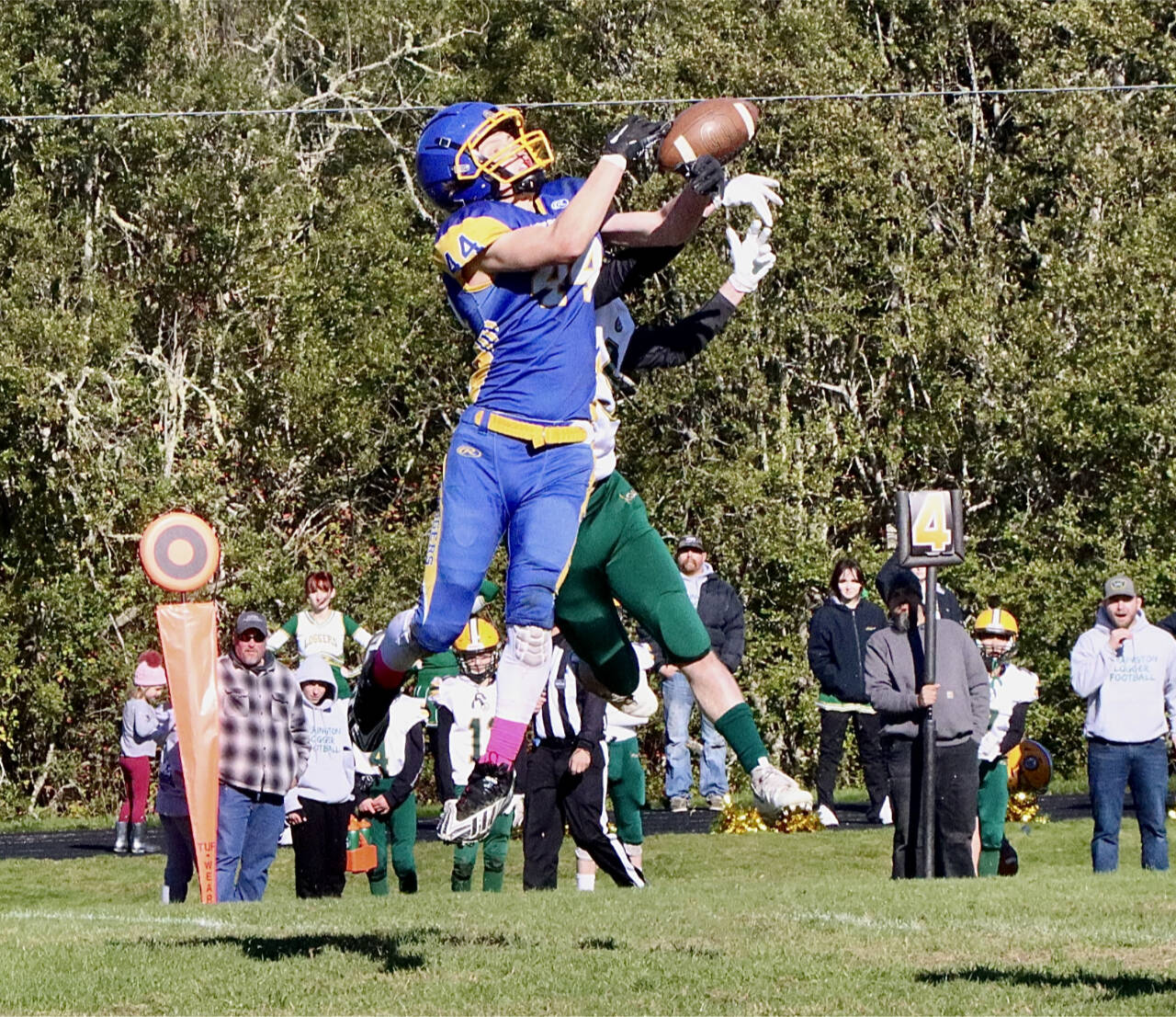 Crescent’s Carter Clifford hauls in a pass under the tight defense of a Darrington player Saturday in Joyce. (Dave Logan/for Peninsula Daily News)