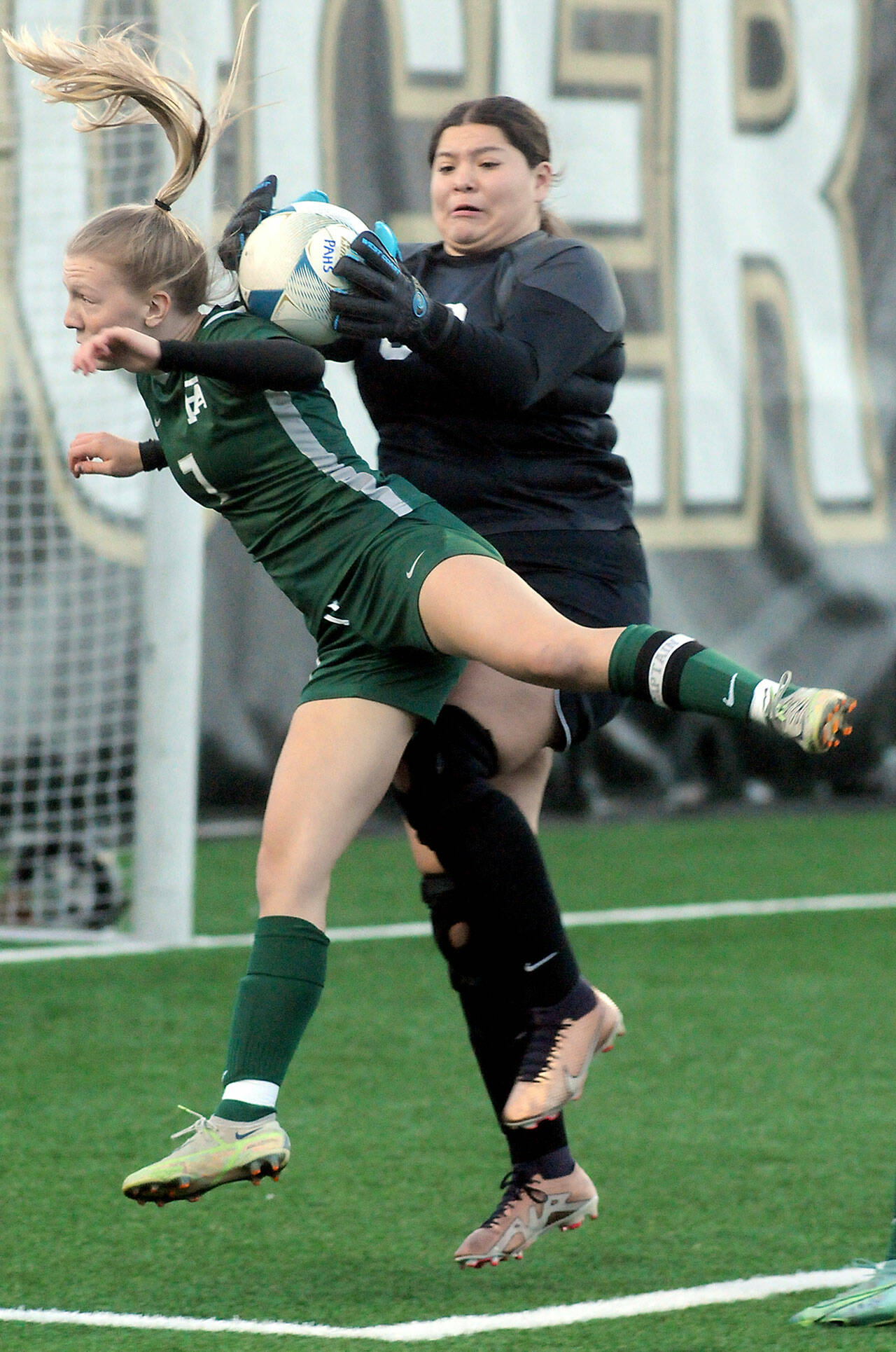 KEITH THORPE/PENINSULA DAILY NEWS Port Angeles’ Izzy Felton, front, gets tangled in the box with Renton goalkeeper Zitlaly Valeriano-Reyes during Tuesday’s bidistrict playoff at Wally Sigmar Field in Port Angeles. Felton had one goal on a header and nearly had two other goals in the 2-0 win.