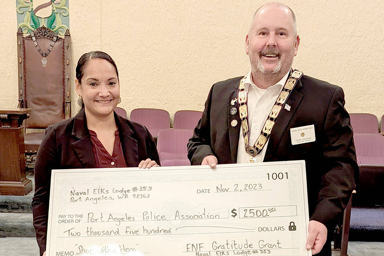 Pictured is Detective Swift Sanchez, on the right, accepting a check from Exalted Ruler John Pearce.