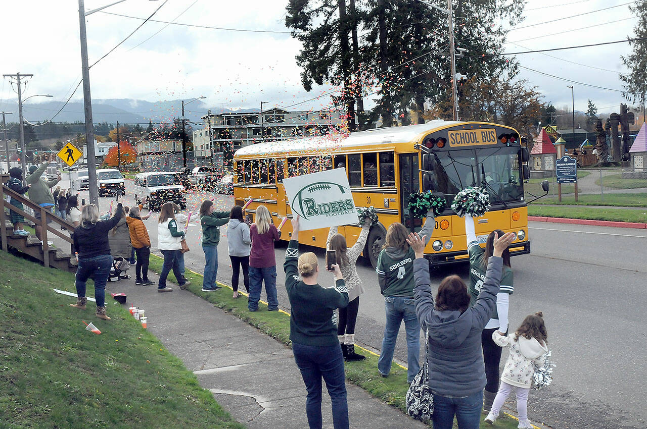 Friends, family and Roughrider fans line Race Street in front of Port Angeles Civic Field as a bus carrying the Port Angeles High School football team heads for Tumwater for Friday’s state playoff opener. The Roughriders were on their first trip to state in more than a decade to play No. 1-seeded Tumwater High School. Dozens of people took part in the team send-off. (KEITH THORPE/PENINSULA DAILY NEWS)