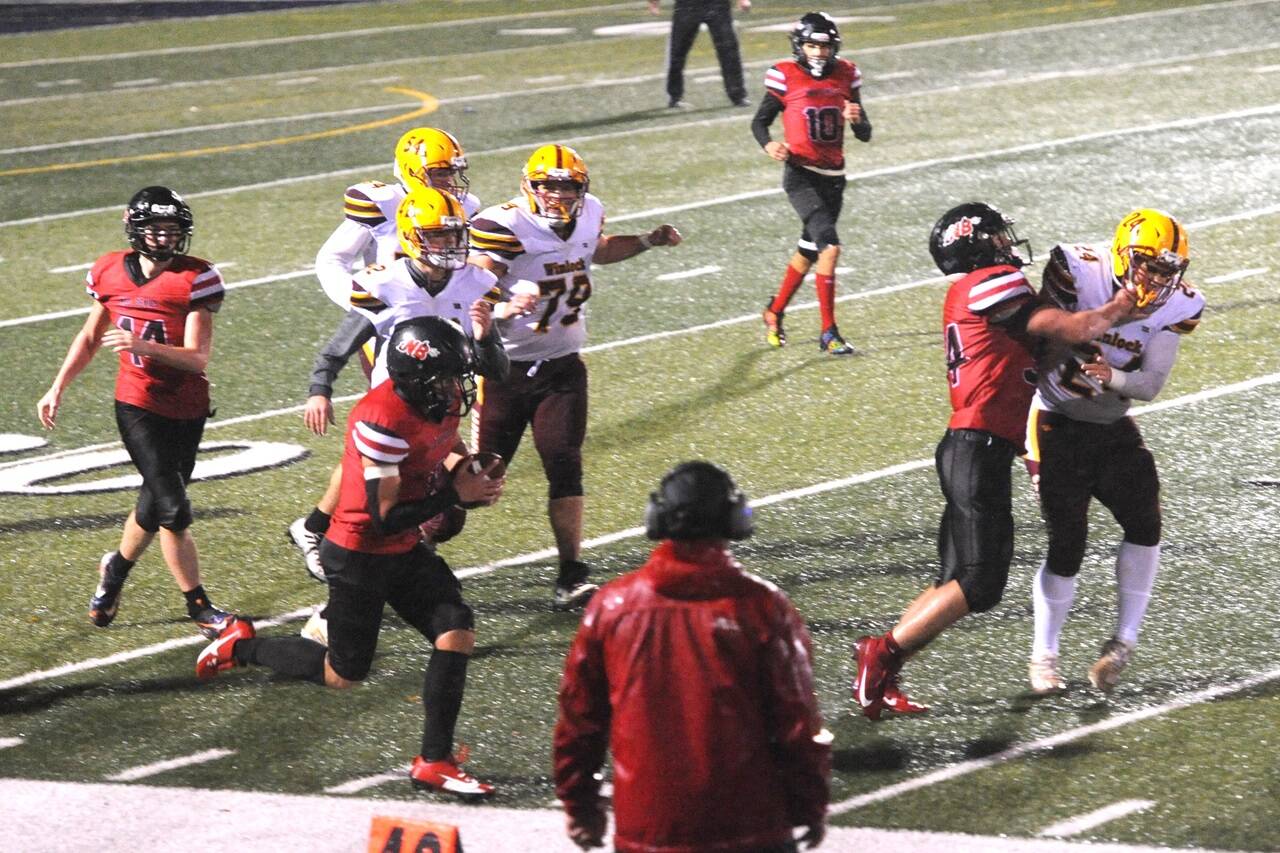 Neah Bay’s Jodell Wimberley runs against Winlock in a fierce rainstorm in Forks on Friday night. Wimberley scored seven touchdowns as Neah Bay won 86-6. (Lonnie Archibald/for Peninsula Daily News)