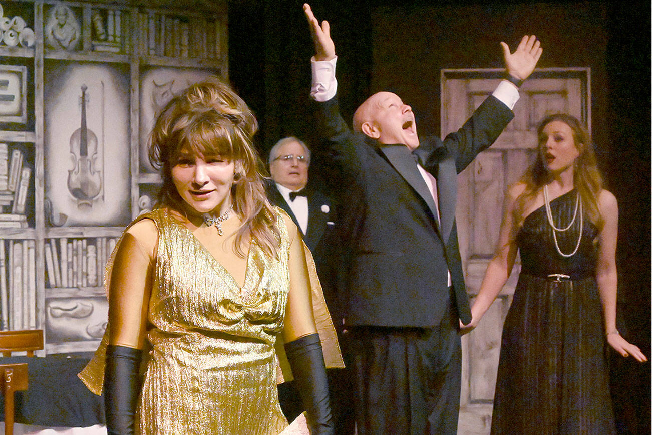 Michael Dashiell/Olympic Peninsula News Group
Acerbic magazine columnist Daria Chase (portrayed by Jamie Pauley) reveals that newly-married Simon Bright (Stephan Willms) has inherited a fortune in an early scene of “The Game’s Afoot or Holmes for the Holidays.” Looking on are host William Gillette (Joel Hoffman) and Bright’s new bridge, Aggie Wheeler (Merrin Packer).