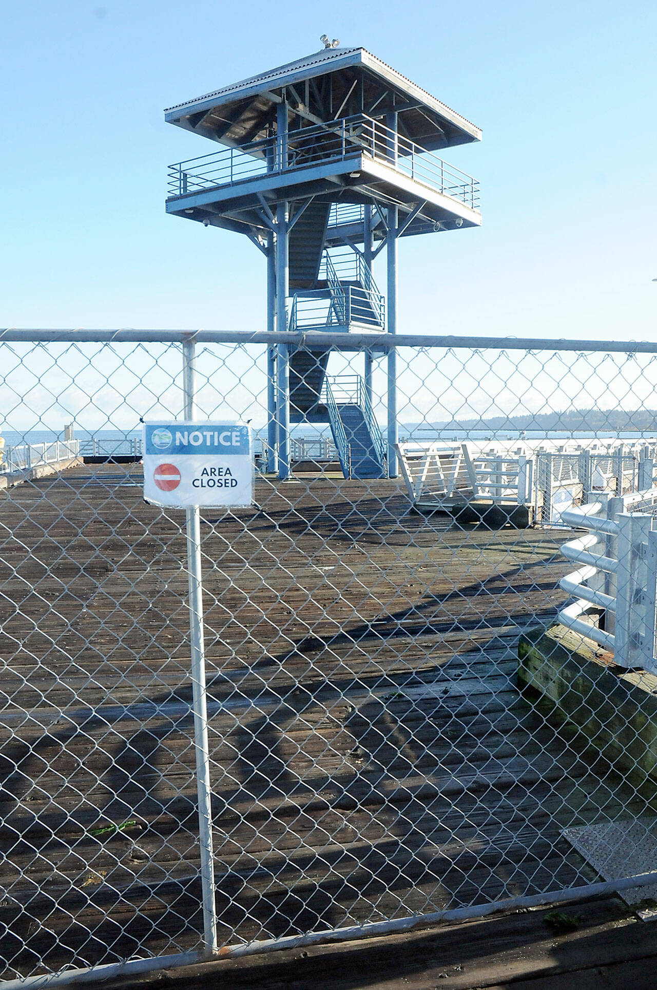 Temporary fencing blocks the end of Port Angeles City Pier at the observation tower after the city closed the area. (Keith Thorpe/Peninsula Daily News)
