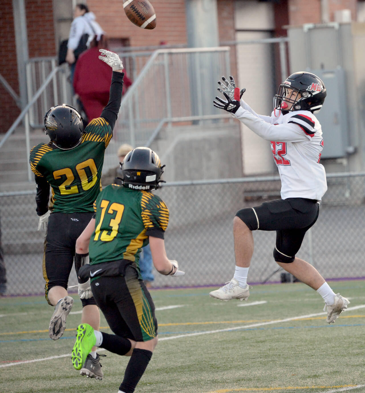Neah Bay’s Adan Ellis goes for a reception at the Apple Bowl in Wenatchee in the state 1B semifinal football game. Ellis had three touchdown catches in the game. Defending on the play are Liberty Bell’s Bodie Thompson (20) and Greyden Paz (13). (Al Camp)