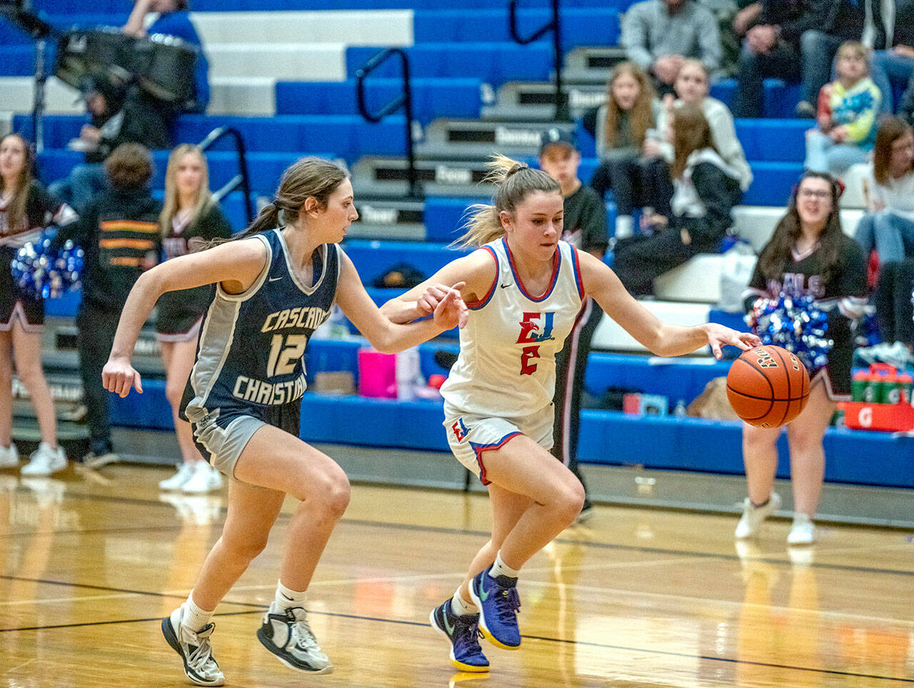 Steve Mullensky/for Peninsula Daily News East Jefferson’s Kaetyn Riley drives for the basket against Cascade Christian’s Leisl Nordling during a game in Chimacum Thursday night.