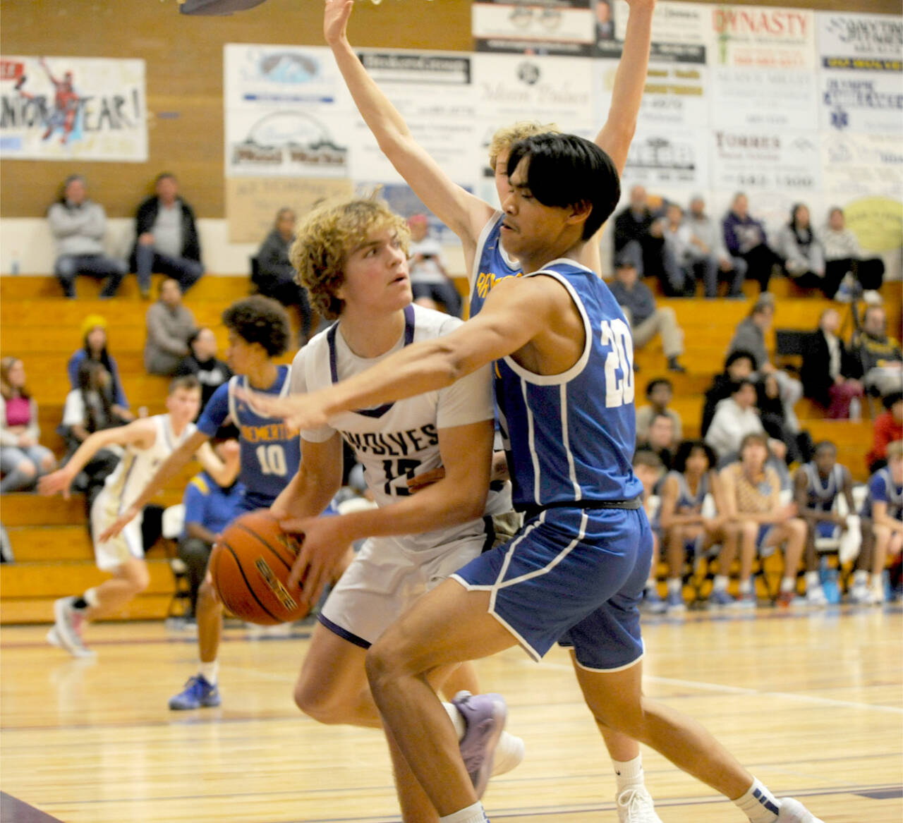 Sequim’s Zeke Schmadeke (15) is guarded tightly by Bremerton’s Isaiah Cadengo (20) on Tuesday night in Sequim. Bremerton won the closely fought contest 69-66. (Matthew Nash/Olympic Peninsula News Group)