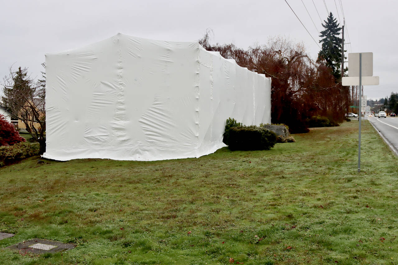 Engine #4 is covered in a tarp in preparation for asbestos removal, which will be followed by restoration. (DAVE LOGAN/FOR PENINSULA DAILY NEWS)