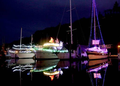 The Port Angeles Boat Haven is all aglow with holiday lights on various boats. Temperatures on the North Olympic Peninsula are forecast to be in the mid- to upper 40s this week with overnight lows dipping into the upper 30s. (Dave Logan/for Peninsula Daily News)