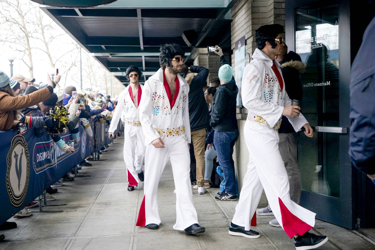 The Vegas Golden Knights arrive dressed like Elvis before the NHL Winter Classic hockey game against the Seattle Kraken, Monday, Jan. 1, 2024, in Seattle. (AP Photo/Lindsey Wasson)