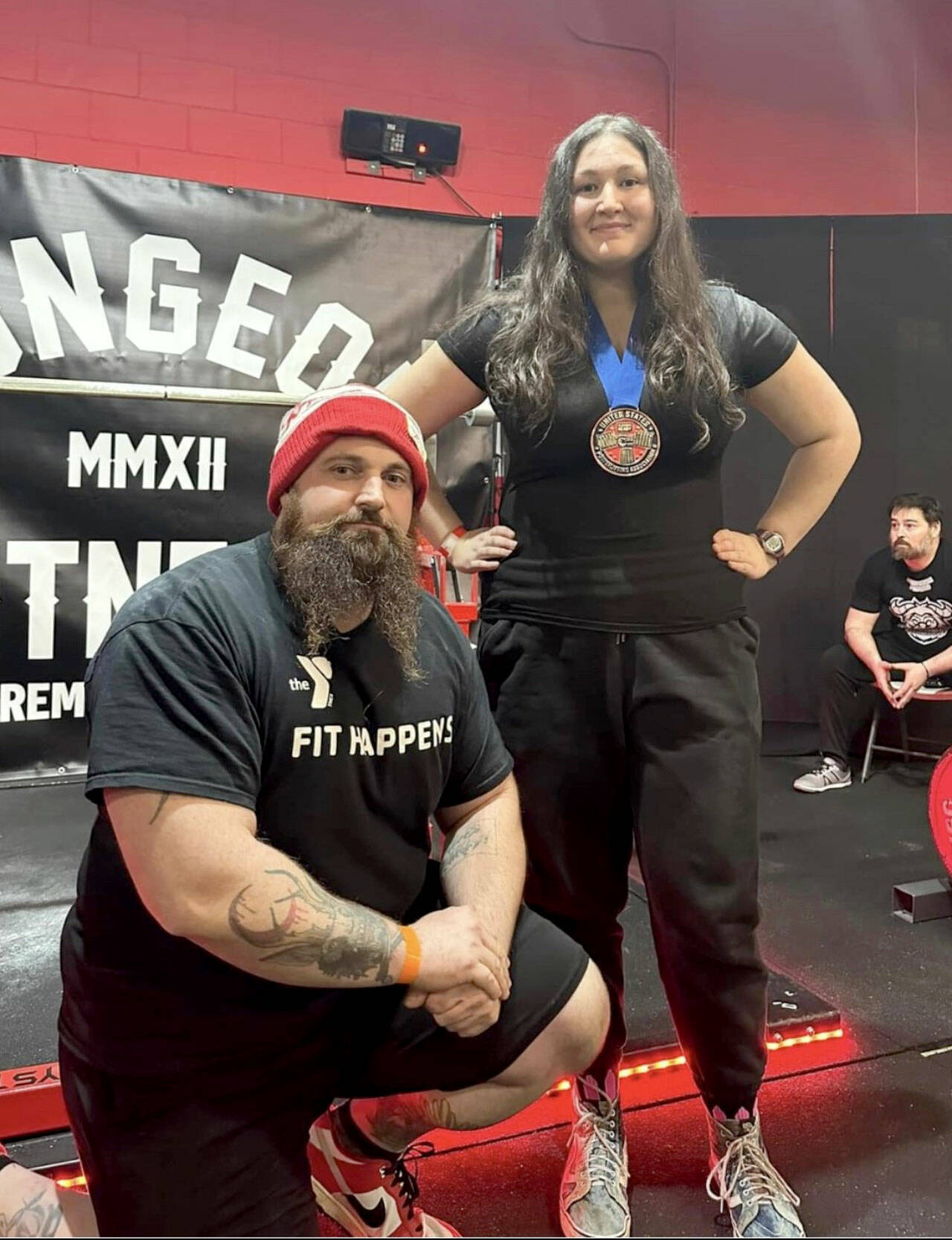 Port Angeles powerlifter Maggie Doyle set four U.S. Powerlifting Association age group records while winning her first powerlifting competition in Bremerton in December. She is shown with her coach, Ryan Fontana of the YMCA of Port Angeles.