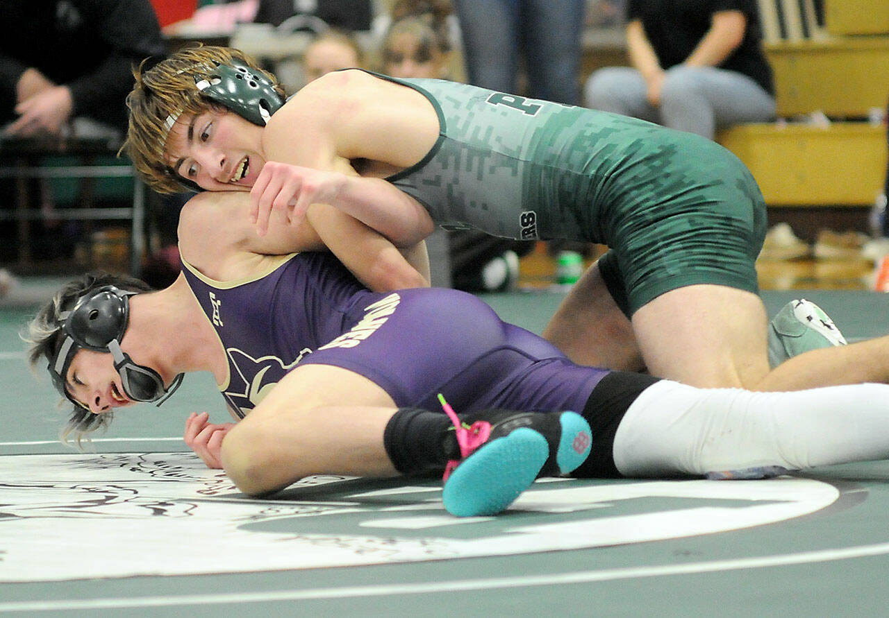 Port Angeles’ Anthony McMahan, top, tries to overturn Sequim’s Jayms Vilona in the 144-pound class on Saturday at Port Angeles High School. (Keith Thorpe/Peninsula Daily News)